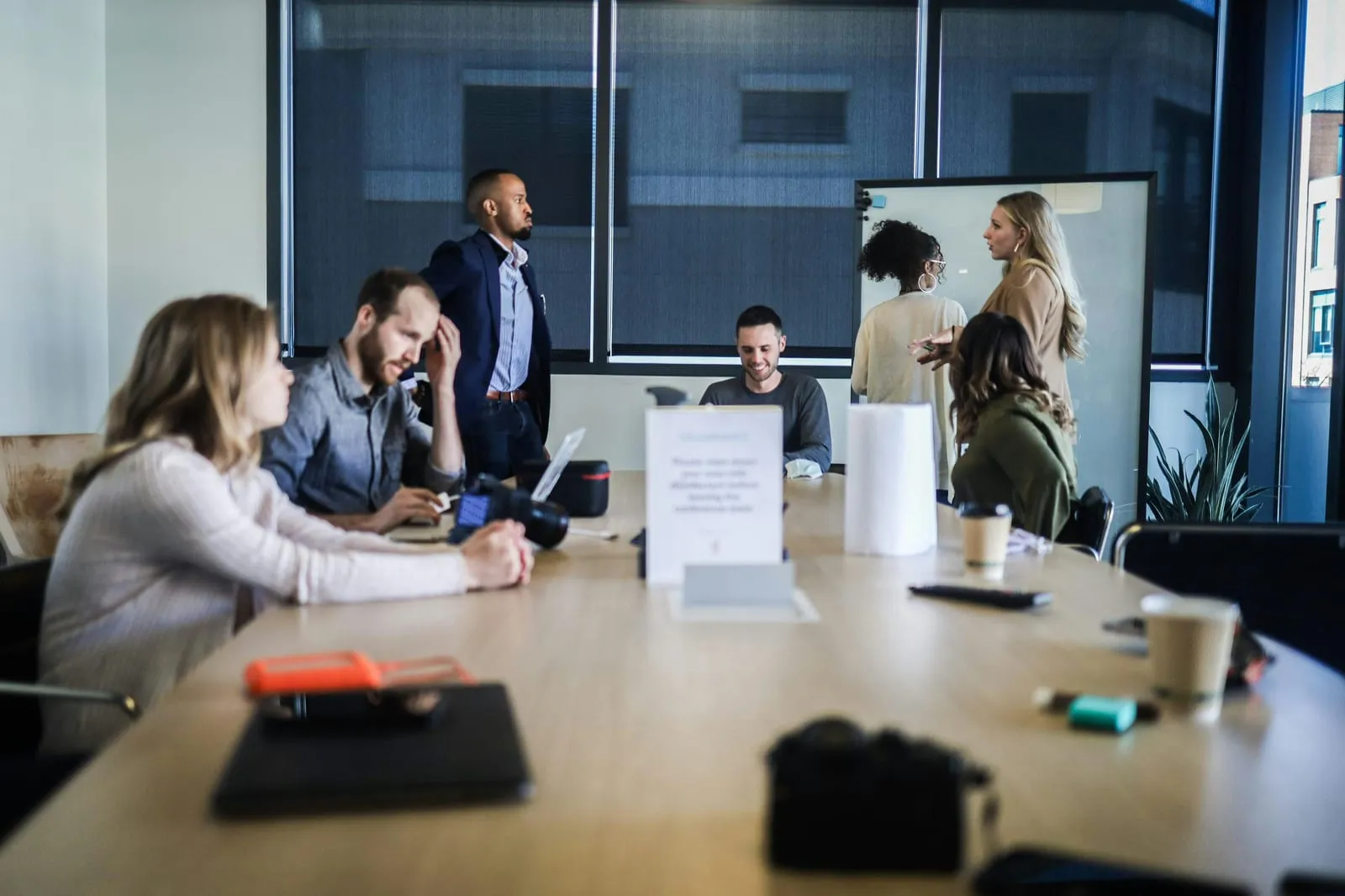 A management team in a glass-walled boardroom discussing AI governance and EU AI Act readiness.